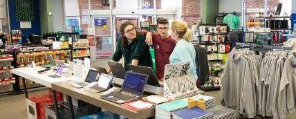 Students looking at laptops in the bookstore.